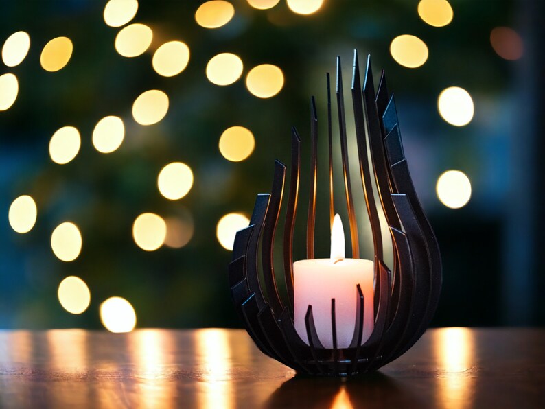 May include: A black metal candle holder shaped like a flame with a white candle inside. The candle holder is on a wooden surface with a blurred background of lights.