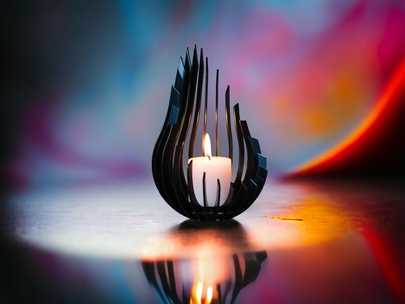 May include: A black metal candle holder shaped like a flame with a white candle inside. The candle is lit and the flame is casting a warm glow. The background is a blurred out colorful gradient of blue, pink, and orange.