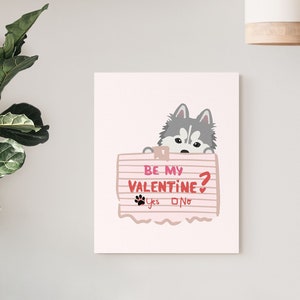 May include: A pink and white Valentine's Day card with a cartoon husky dog peeking over the top. The card says "Be my Valentine?" with a yes or no checkbox.