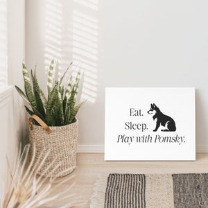 May include: Black and white illustration of a dog sitting on a white background with the text "Eat. Sleep. Play with Pomsky."
