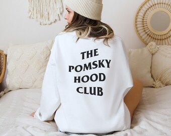 May include: White sweatshirt with black text that reads "THE POMSKY HOOD CLUB".