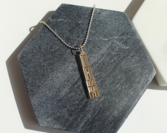 Dom Tower necklace of gold mirrored plexiglass. Carry the Dom of Utrecht with you everywhere.