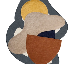 May include: Abstract rug with a blue, beige, brown, and yellow color scheme. The rug is made of different shapes and sizes.