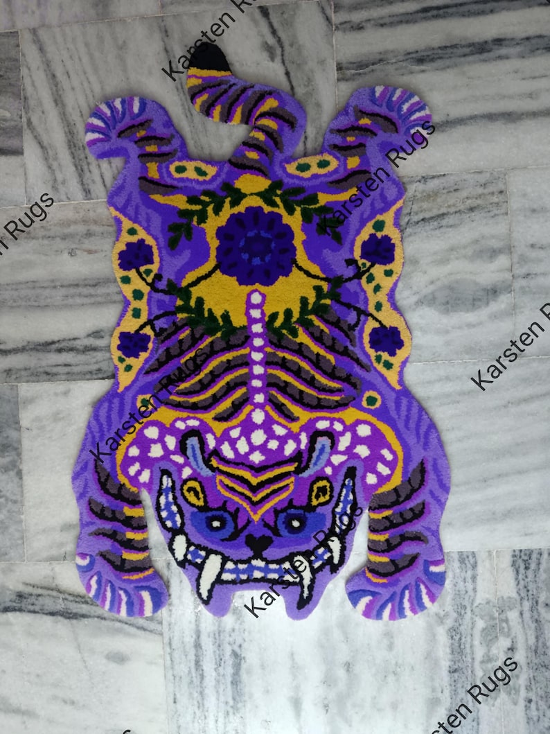 May include: Purple and yellow tiger rug with floral details. The rug is made of wool and has a shaggy texture.