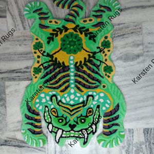 May include: Green and yellow tiger rug with a floral design in the center. The rug is made of a soft, plush material and is perfect for adding a touch of whimsy to any room.