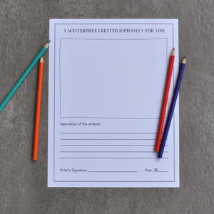 May include: A white art print with the text "A MASTERPIECE CREATED ESPECIALLY FOR YOU". The print includes space for artwork description, artist signature, and year. Colored pencils in teal, orange, red, and purple are arranged around the print.