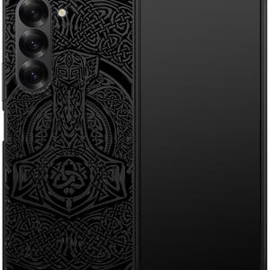 May include: A black phone case with a detailed design of a hammer and Celtic knotwork. The phone case is designed for a foldable phone.