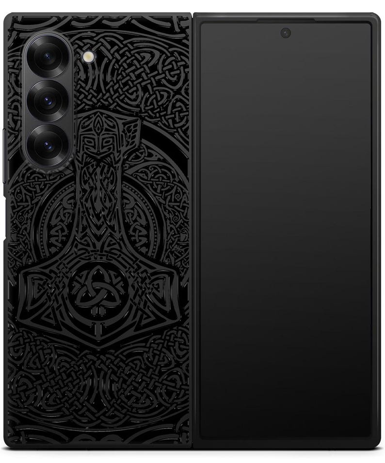 May include: A black phone case with a detailed design of a hammer and Celtic knotwork. The phone case is designed for a foldable phone.