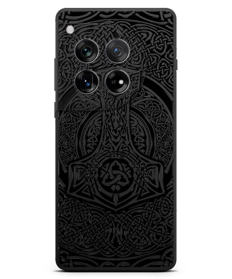 May include: Black phone case with a detailed design of a hammer and Celtic knotwork.