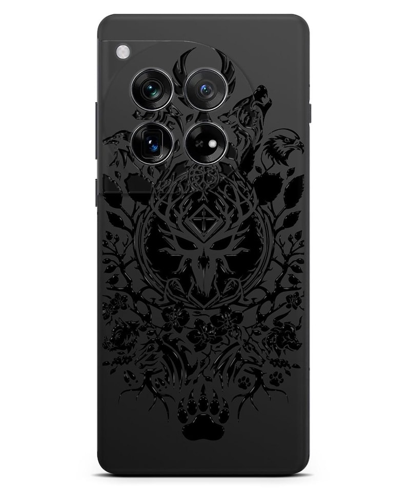 Puede incluir: Carcasa de tel&eacute;fono negra con un dise&ntilde;o detallado de una calavera de ciervo, un lobo y un cuervo. El dise&ntilde;o est&aacute; en blanco y negro y tiene un estilo tribal.