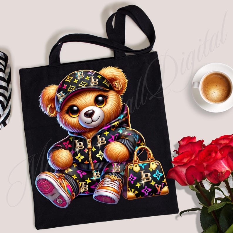 May include: Black tote bag with a cartoon teddy bear wearing a black and white patterned hoodie, a black and white patterned hat, and holding a black and white patterned handbag. The teddy bear has brown fur and big brown eyes.