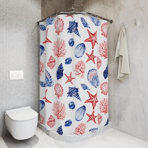 May include: White shower curtain with a nautical design featuring red starfish, coral, and blue seashells. The curtain is hanging in a bathroom with a white toilet and a tiled wall. A towel hangs on the wall.