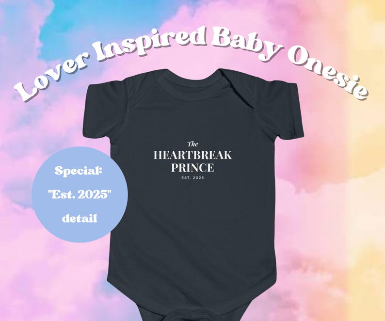 May include: A dark gray baby onesie with the text "The HEARTBREAK PRINCE EST. 2025". The words "Lover Inspired Baby Onesie" are arched above the onesie. A light blue circle reads "Special: 'Est. 2025' detail".