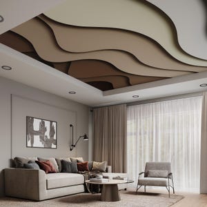May include: A living room with a modern, abstract ceiling design featuring wavy, layered shapes in shades of brown and beige. The room has a large, gray sectional sofa with pillows, a coffee table, and a gray armchair. The windows are covered with sheer curtains.