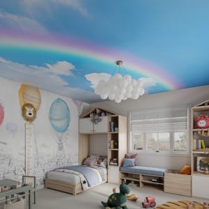 May include: A child's bedroom with a blue and white cloud ceiling mural, a rainbow, and a white cloud chandelier. The room features a wooden bed with a blue and white bedding set, a wooden bookshelf, and a window with white blinds. There are toys on the floor, including a green dinosaur and a red toy truck.