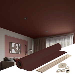 May include: A rolled up brown ceiling tile with a white trim and a white plastic installation kit. The kit includes a circular base, four smaller round bases, and six long, thin, white strips.
