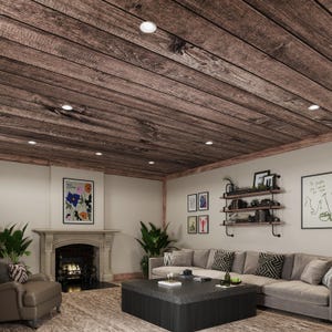 May include: A living room with a wood-paneled ceiling, a gray sectional sofa, a coffee table, a fireplace, and plants. The walls are painted white and there are several framed pictures on the wall.