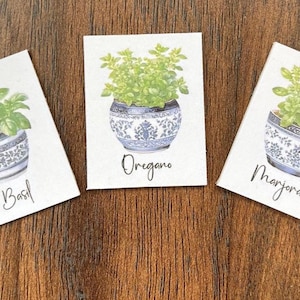 May include: Three white cards with illustrations of potted herbs. The cards are labelled "Basil", "Oregano", and "Marjoram".