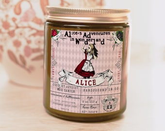 May include: A glass jar candle with a pink and white label featuring an illustration of Alice in Wonderland. The label reads "Alice's Adventures in Wonderland" and "Alice Coconut Apricot Wax Candle Handpoured in Co.". The candle is 8 oz/223 g and has a burn time of 40+ hours.