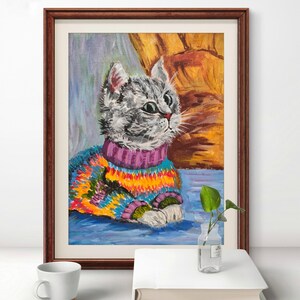 Chat d'hiver dans un pull coloré, amoureux des animaux