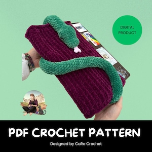 May include: A digital PDF crochet pattern featuring a plush, burgundy-colored rectangle with a green snake wrapped around it. The snake has a pink tongue. The text "PDF CROCHET PATTERN" is displayed at the bottom, along with "Designed by CoRo Crochet". A green circle with "DIGITAL PRODUCT" is also visible.