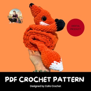 May include: A plush, orange crocheted fox with a white-tipped tail and black accents. The fox is curled up, held by a hand, and has large, round eyes. The image includes the text "PDF CROCHET PATTERN" and "DIGITAL PRODUCT".