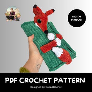 May include: A handmade crochet fox toy with a green rectangular base. The fox is red with white and black accents. The text "PDF CROCHET PATTERN" is displayed at the bottom of the image. Designed by CoRo Crochet.