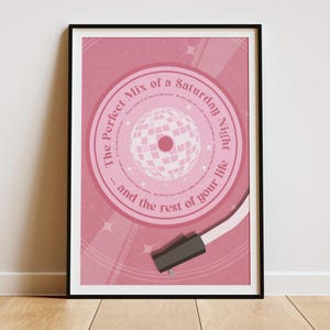 Puede incluir: Un estampado rosa enmarcado con un diseño de bola de discoteca. El estampado incluye el texto "The Perfect Mix of a Saturday Night... and the rest of your life" en un círculo alrededor de la bola de discoteca.
