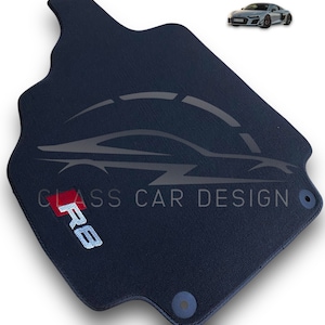 May include: A black car floor mat with the text "CLASS CAR DESIGN" and "RS" embroidered in white and red.