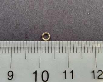 May include: A gold jump ring measuring approximately 10 mm in diameter, shown next to a ruler.