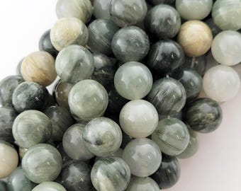 May include: A strand of round, green and white gemstone beads. The beads have a striated pattern and are approximately 8mm in diameter.