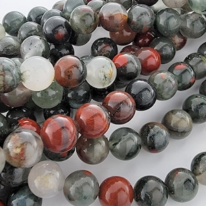 May include: A strand of round, multi-colored gemstone beads. The beads are a mix of green, red, and white with a mottled, marbled appearance.