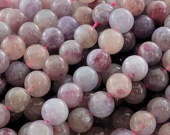 May include: A strand of round, purple and white gemstone beads. The beads are smooth and polished, with a slight shimmer.