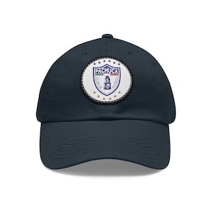 Puede incluir: Una gorra de béisbol azul marino con un parche blanco que presenta el logotipo del Pachuca Club de Fútbol. El logotipo incluye una torre, un balón de fútbol y las palabras "Pachuca Club de Fútbol".