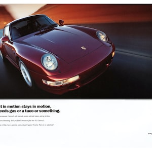 May include: A red Porsche 911 Carrera S sports car driving on a road. The car has large wheels and a black interior. The text on the image reads: "An object in motion stays in motion, until it needs gas or a taco or something."