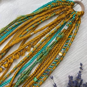 Dreadlocks with an elastic band,  Copper on green, orange, yellow braids and Senegalese dreadlock extensions, soft set in boho style, c