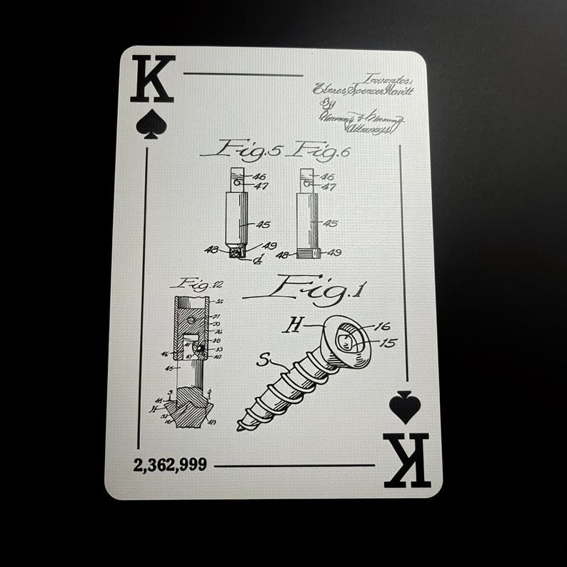 May include: A playing card featuring a black and white technical drawing of a screw and other mechanical components. The card is marked with the King of Spades symbol and the number 2,362,999. The card also includes the name of the inventor.