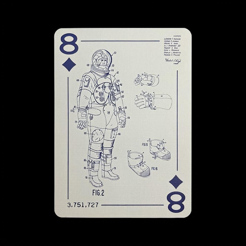 May include: Playing card featuring a blue diagram of an astronaut suit, labeled "FIG.2" and "3.751,727". The card is off-white with blue suit details, the number "8" and a diamond symbol in the corners.