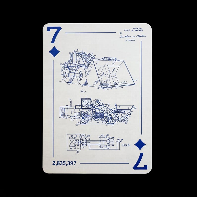 May include: Playing card featuring a blue diagram of a front-end loader on a white background. The card is a seven of diamonds, with the number 7 and a diamond symbol in the corners. The card also has the patent number 2,835,397.