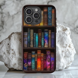 May include: A phone case with a design of a bookshelf filled with colorful, antique-looking books. The case has a black background and a camera lens cutout.