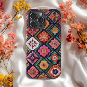 May include: A black phone case with a colorful geometric pattern featuring flowers and intricate designs. The case has a camera lens cutout and a raised lip around the edges.