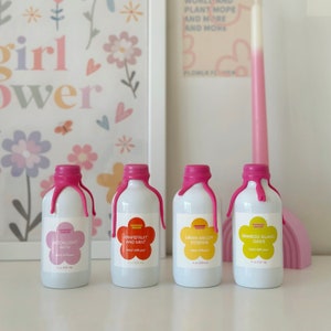 May include: Four white reed diffusers with pink wax seals and labels. The labels feature floral designs and the scents: Moonlight Path, Grapefruit and Mint, Green Melon Essense, and Bamboo Island Oasis. Each bottle is 4 oz (120 ml).