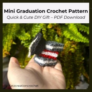 May include: A mini graduation crochet pattern in black, white, and red, held in a hand. The crochet item resembles a graduation cap and a stack of books. Text on the image reads "Mini Graduation Crochet Pattern" and "Quick & Cute DIY Gift - PDF Download."