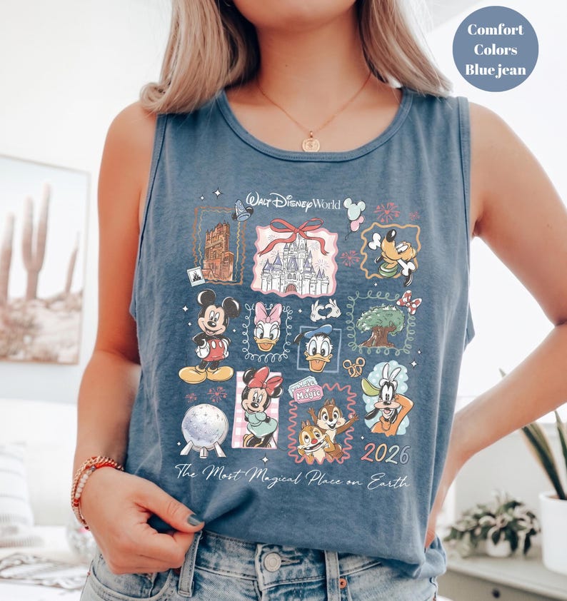 May include: Blue jean tank top featuring a colorful graphic of Disney characters and landmarks. The design includes Mickey Mouse, Donald Duck, and Cinderella's castle. Text on the shirt reads "Walt Disney World" and "The Most Magical Place on Earth."