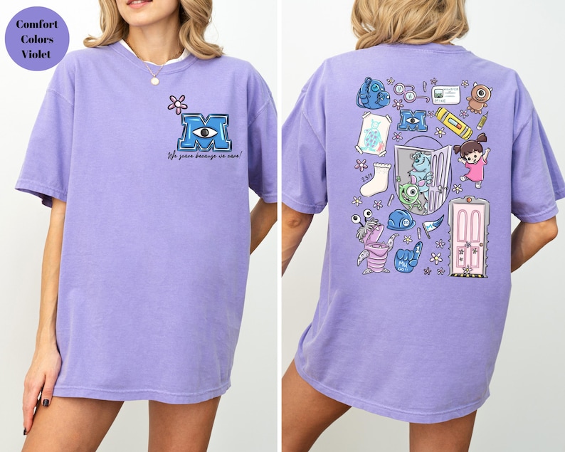 May include: A light purple t-shirt with a white collar. The front features a blue and white eye design with the letter "M" and the text "We scare because we care!" The back has cartoon character graphics.
