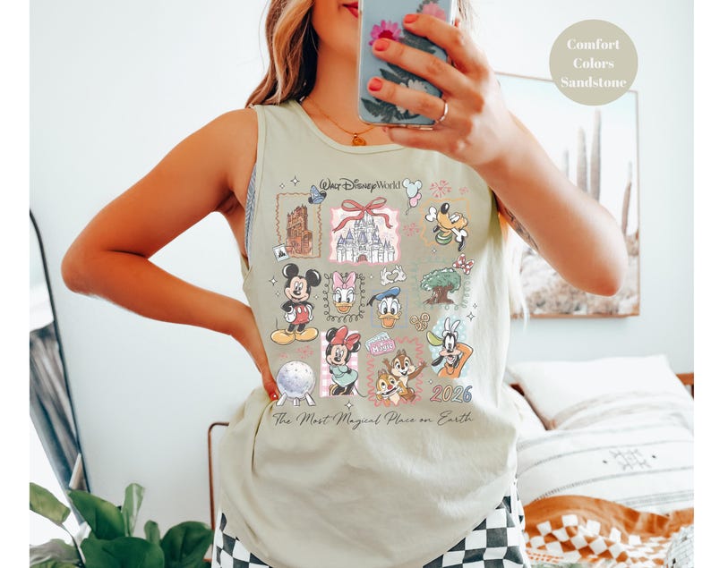 May include: A light green tank top featuring a collage of Disney characters and landmarks. The design includes Mickey Mouse, Minnie Mouse, Donald Duck, and Chip and Dale, with the text "Walt Disney World" and "The Most Magical Place on Earth".