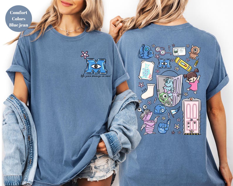 May include: Blue jean colored t-shirt featuring a cartoon design from the movie Monsters, Inc. The front has a blue letter "M" with an eye and the text "We scare because we care!". The back has various cartoon characters and objects.