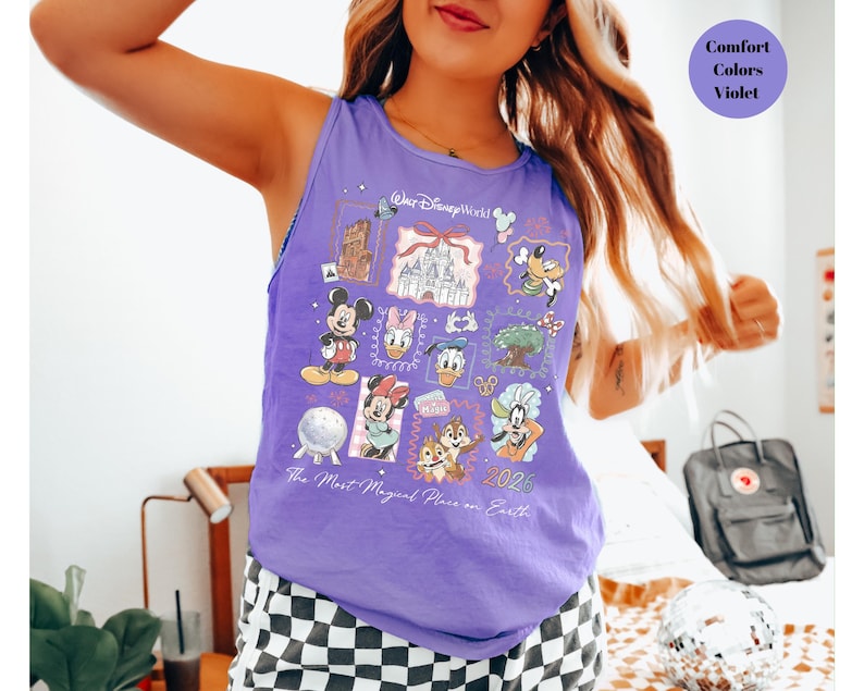 May include: A sleeveless purple tank top featuring a colorful graphic design with Disney characters and landmarks. The design includes Mickey Mouse, Minnie Mouse, Donald Duck, and Chip and Dale. Text on the shirt reads "Walt Disney World" and "The Most Magical Place on Earth 2026."