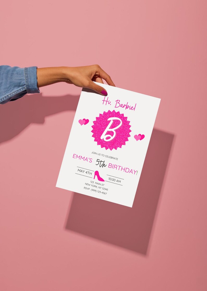 May include: A white invitation card with pink text and graphics, held against a pink background. The card reads "Hu. Barbiel" and "Emma's 5th Birthday!" with a pink high heel graphic. The invitation includes date, time, and location details.