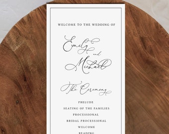 May include: A white wedding ceremony order of service with black text. The order of service lists the order of events for the wedding of Emily and Michael. The text includes "Welcome to the Wedding of", "The Ceremony", "Prelude", "Seating of the Families", "Processional", "Bridal Processional", "Welcome", "Reading", "Exchange of Vows", "Exchange of Rings", "Pronouncement", "Recessional", and "Cocktails, Dinner, and Dancing to Follow."